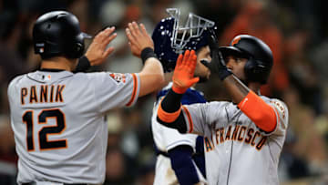SAN DIEGO, CA - APRIL 12: Joe Panik #12 and Andrew McCutchen #22 celebrate after both scored on a double by Buster Posey #28 of the San Francisco Giants as Austin Hedges #18 of the San Diego Padres looks on during the sixth inning of a game at PETCO Park on April 12, 2018 in San Diego, California. (Photo by Sean M. Haffey/Getty Images)