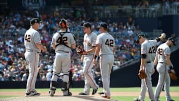 SAN DIEGO, CA - APRIL 15: San Francisco Giants manager Bruce Bochy, (L) waits as Derek Law #64, (C) comes into the game during the sixth inning of a baseball game against the San Diego Padres at PETCO Park on April 15, 2018 in San Diego, California. All players are wearing #42 in honor of Jackie Robinson Day. (Photo by Denis Poroy/Getty Images)
