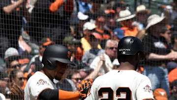 SAN FRANCISCO, CA - MAY 16: Andrew McCutchen #22 of the San Francisco Giants in congratulated by Miguel Gomez #52 after McCutchen scored against the Cincinnati Reds in the bottom of the first inning at AT&T Park on May 16, 2018 in San Francisco, California. (Photo by Thearon W. Henderson/Getty Images)