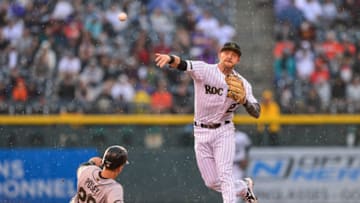 DENVER, CO - MAY 28: Trevor Story #27 of the Colorado Rockies throws past Buster Posey #28 of the San Francisco Giants to complete a third inning double play during a game at Coors Field on May 28, 2018 in Denver, Colorado. (Photo by Dustin Bradford/Getty Images)