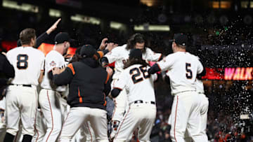 SAN FRANCISCO, CA - JUNE 27: Brandon Crawford #35 of the San Francisco Giants is congratulated by teammates after he hit a walk off home run in the ninth inning to beat the Colorado Rockies at AT&T Park on June 27, 2018 in San Francisco, California. (Photo by Ezra Shaw/Getty Images)