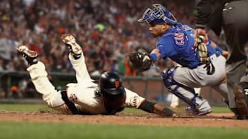 SAN FRANCISCO, CA - JULY 09: Alen Hanson #19 of the San Francisco Giants beats the tag of Willson Contreras #40 of the Chicago Cubs to score after a failed pick off attempt in the fifth inning at AT&T Park on July 9, 2018 in San Francisco, California. Hanson scored all the way from first base on the play. (Photo by Ezra Shaw/Getty Images)
