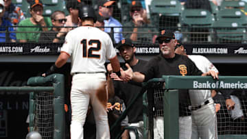 SAN FRANCISCO, CA - SEPTEMBER 12: Joe Panik #12 of the San Francisco Giants is congratulated by manager Bruce Bochy #15 after Panik scored against the Atlanta Braves in the bottom of the third inning at AT&T Park on September 12, 2018 in San Francisco, California. (Photo by Thearon W. Henderson/Getty Images)