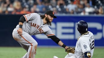 SAN DIEGO, CA - SEPTEMBER 17: Franmil Reyes #32 of the San Diego Padres is tagged out at second base by Brandon Crawford #35 of the San Francisco Giants as he tries to stretch a single during the sixth inning of a baseball game at PETCO Park on September 17, 2018 in San Diego, California. (Photo by Denis Poroy/Getty Images)