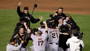 ARLINGTON, TX - NOVEMBER 01: Catcher Buster Posey #28, Aubrey Huff #17, Freddy Sanchez #21 and Matt Cain #18 (top L) of the San Francisco Giants celebrate on the field with their teammates after the Giants won 3-1 against the Texas Rangers in Game Five of the 2010 MLB World Series at Rangers Ballpark in Arlington on November 1, 2010 in Arlington, Texas. (Photo by Elsa/Getty Images)