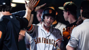 DENVER, CO - JULY 16: Mike Yastrzemski #5 of the San Francisco Giants is congratulated in the dugout after hitting a solo home run in the ninth inning against the Colorado Rockies at Coors Field on July 16, 2019 in Denver, Colorado. (Photo by Dustin Bradford/Getty Images)