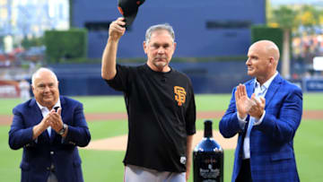 SAN DIEGO, CALIFORNIA - JULY 26: Executive chairman of the ownership group of the San Diego Padres Ron Fowler, and former MLB player Mark Sweeney congratulate manager Bruce Bochy of the San Francisco Giants as he acknowledges the crowd regarding his upcoming retirement during a pregame ceremony prior to a game between the San Diego Padres and the San Francisco Giants at PETCO Park on July 26, 2019 in San Diego, California. (Photo by Sean M. Haffey/Getty Images)