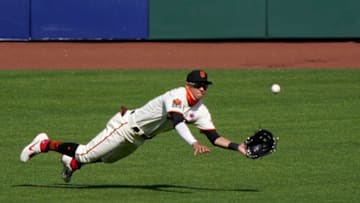 Mauricio Dubón #1 of the SF Giants makes a diving catch taking a hit away from Vimael Machin #39 of the Oakland Athletics in the top of the ninth inning at Oracle Park on August 16, 2020 in San Francisco, California. The Athletics won the game 15-3. (Photo by Thearon W. Henderson/Getty Images)