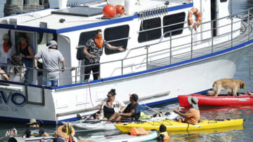 Retired SF Giants player Hunter Pence throws a signed ball to a fan from a boat in McCovey Cove outside the Stadium during the game between the San Francisco Giants and the San Diego Padres at Oracle Park on September 27, 2020 in San Francisco, California. (Photo by Lachlan Cunningham/Getty Images)