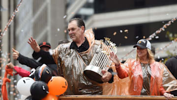 SAN FRANCISCO, CA - OCTOBER 31: Manager Bruce Bochy #15 of the San Francisco Giants, holding the Commissioner's Trophy waves to the crowd along the parade route during the San Francisco Giants World Series victory parade on October 31, 2014 in San Francisco, California. The San Francisco Giants beat the Kansas City Royals to win the 2014 World Series. (Photo by Thearon W. Henderson/Getty Images)