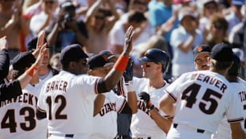 SAN FRANCISCO - OCTOBER: Manager Dusty Baker #12 and Will Clark #22 of the San Francisco Giants high five teammates against the Chicago Cubs during the 1989 National League Championship Series at Candlestick Park in October 1989 in San Francisco, California. (Photo by Otto Greule Jr/Getty Images)