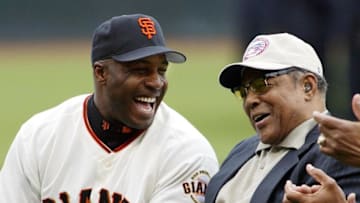 SF Giants slugger Barry Bonds laughs with godfather Giants legend Willie Mays at Giants Opening Day against the San Diego Padres in 2002. (JOHN G. MABANGLO/AFP via Getty Images)