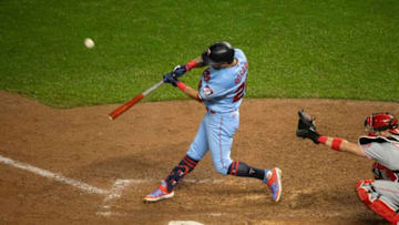 Sep 26, 2020; Minneapolis, Minnesota, USA; Minnesota Twins left fielder Eddie Rosario (20) hits a sacrifice fly against the Cincinnati Reds during the seventh inning at Target Field. Mandatory Credit: Jordan Johnson-USA TODAY Sports