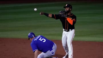 SF Giants second baseman Arismendy Alcntara turns the double play while avoiding Los Angeles Dodgers shortstop Corey Seager (5) in the third inning during a spring training game at Scottsdale Stadium. Mandatory Credit: Rick Scuteri-USA TODAY Sports