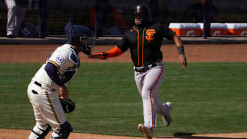 SF Giants outfielder Heliot Ramos (80) scores a run in front of Milwaukee Brewers catcher Omar Narvaez (10) during a spring training game at American Family Fields of Phoenix. (Rick Scuteri-USA TODAY Sports)