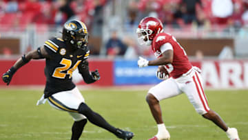Nov 26, 2021; Fayetteville, Arkansas, USA; Arkansas Razorbacks wide receiver De'Vion Warren (10) runs after a catch as Missouri Tigers defensive back Allie Green IV (24) defends in the third quarter at Donald W. Reynolds Razorbacks Stadium. Arkansas won 34-17. Mandatory Credit: Nelson Chenault-USA TODAY Sports