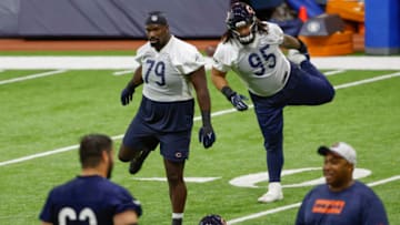 Jun 8, 2022; Lake Forest, IL, USA; Chicago Bears defensive line Auzoyah Alufohai (79) and defensive line Khyiris Tonga (95) warm up during organized team activities at Halas Hall. Mandatory Credit: Kamil Krzaczynski-USA TODAY Sports
