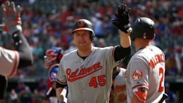 ARLINGTON, TX - AUGUST 5: Mark Trumbo #45 of the Baltimore Orioles celebrates with teammates after hitting his second home run of the game against the Texas Rangers during the seventh inning at Globe Life Park in Arlington on August 5, 2018 in Arlington, Texas. The Orioles won 9-6. (Photo by Ron Jenkins/Getty Images)