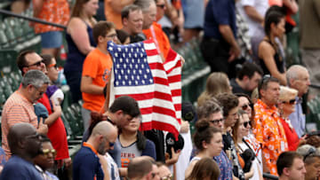 BALTIMORE, MARYLAND - MAY 27: Fans hold up an American flag during a moment of silence for Memorial Day during the Baltimore Orioles and Detroit Tigers game at Oriole Park at Camden Yards on May 27, 2019 in Baltimore, Maryland. (Photo by Rob Carr/Getty Images)