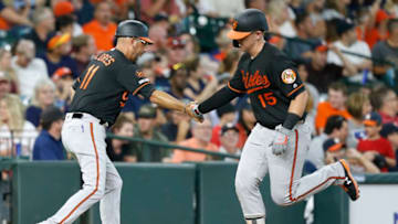 HOUSTON, TEXAS - JUNE 07: Chance Sisco #15 of the Baltimore Orioles receives congratulations from third base coach Jose David Flores #11 after hitting a home run in the third inning against the Houston Astros at Minute Maid Park on June 07, 2019 in Houston, Texas. (Photo by Bob Levey/Getty Images)