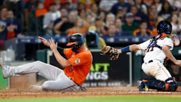 HOUSTON, TEXAS - JUNE 08: Trey Mancini #16 of the Baltimore Orioles scores in the eighth inning as Garrett Stubbs #11 of the Houston Astros is unable to make the tag at Minute Maid Park on June 08, 2019 in Houston, Texas. (Photo by Bob Levey/Getty Images)