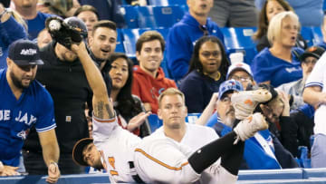 TORONTO, ONTARIO - SEPTEMBER 24: Rio Ruiz #14 of the Baltimore Orioles makes a catch in foul territory against the Toronto Blue Jays in the second inning during their MLB game at the Rogers Centre on September 24, 2019 in Toronto, Canada. (Photo by Mark Blinch/Getty Images)