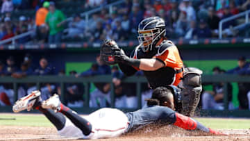NORTH PORT, FL - FEBRUARY 22: Chance Sisco #15 of the Baltimore Orioles tries to tag Ozzie Albies #1 of the Atlanta Braves during a Grapefruit League spring training game at CoolToday Park on February 22, 2020 in North Port, Florida. The Braves defeated the Orioles 5-0. (Photo by Joe Robbins/Getty Images)