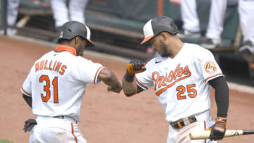 BALTIMORE, MD - AUGUST 02: Cedric Mullins #31 of the Baltimore Orioles celebrates scoring a run with Anthony Santander #25 on a Hanser Alberto #57 (not pictured) double in the seventh inning during a baseball game against the Tampa Bay Rays on August 2, 2020 at Oriole Park at Camden Yards in Baltimore, Maryland. (Photo by Mitchell Layton/Getty Images)