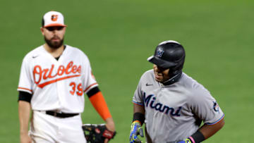 BALTIMORE, MARYLAND - AUGUST 04: Jesus Aguilar #24 of the Miami Marlins rounds the bases in front of Renato Nunez #39 of the Baltimore Orioles hitting a solo home run in the eighth inning at Oriole Park at Camden Yards on August 04, 2020 in Baltimore, Maryland. (Photo by Rob Carr/Getty Images)