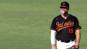 BALTIMORE, MARYLAND - AUGUST 05: First basemen Chris Davis #19 of the Baltimore Orioles blows a bubble during the third inning against the Miami Marlins during game one of a doubleheader at Oriole Park at Camden Yards on August 05, 2020 in Baltimore, Maryland. (Photo by Rob Carr/Getty Images)
