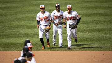 BALTIMORE, MD - AUGUST 23: Anthony Santander #25 of the Baltimore Orioles runs with Cedric Mullins #31 and Mason Williams #38 to shake hands with teammates after the game against the Boston Red Sox at Oriole Park at Camden Yards on August 23, 2020 in Baltimore, Maryland. (Photo by Scott Taetsch/Getty Images)