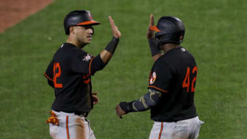 BUFFALO, NEW YORK - AUGUST 28: Jose Iglesias #42 of the Baltimore Orioles and teammate Hanser Alberto #42 celebrate after both scoring on a throwing error by Travis Shaw #42 of the Toronto Blue Jays during the sixth inning at Sahlen Field on August 28, 2020 in Buffalo, New York. All players are wearing #42 in honor of Jackie Robinson Day. The day honoring Jackie Robinson, traditionally held on April 15, was rescheduled due to the COVID-19 pandemic. The Blue Jays are the home team and are playing their home games in Buffalo due to the Canadian government’s policy on coronavirus (COVID-19). (Photo by Bryan M. Bennett/Getty Images)