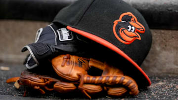 A Baltimore Orioles hat is pictured with Franklin batting gloves during the game. (Photo by Nic Antaya/Getty Images)