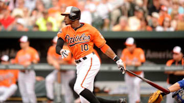 BALTIMORE, MD - MAY 26: Adam Jones #10 of the Baltimore Orioles hits a triple in the third inning to extend hit hitting streak to seventeen games during a baseball game against the Kansas City Royals at Oriole Park at Camden Yards on May 26, 2012 in Baltimore, Maryland. (Photo by Mitchell Layton/Getty Images)