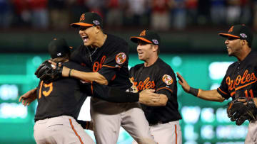 ARLINGTON, TX - OCTOBER 05: (L-R) Chris Davis #19, Manny Machado #13, J.J. Hardy #2 and Robert Andino #11 of the Baltimore Orioles celebrate after they won 5-1 against the Texas Rangers during the American League Wild Card playoff game at Rangers Ballpark in Arlington on October 5, 2012 in Arlington, Texas. (Photo by Ronald Martinez/Getty Images)