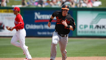 CLEARWATER, FL - MARCH 25: Chance Sisco #15 of the Baltimore Orioles rounds the bases to score on a double by Anthony Santander in the fifth inning of a Grapefruit League spring training game against the Philadelphia Phillies at Spectrum Field on March 25, 2018 in Clearwater, Florida. The Orioles won 6-5. (Photo by Joe Robbins/Getty Images)