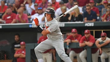 Omaha, NE - JUNE 28: Catcher Adley Rutschman #35 of the Oregon State Beavers singes in a run in the first inning against the Arkansas Razorbacks during game three of the College World Series Championship Series on June 28, 2018 at TD Ameritrade Park in Omaha, Nebraska. (Photo by Peter Aiken/Getty Images)
