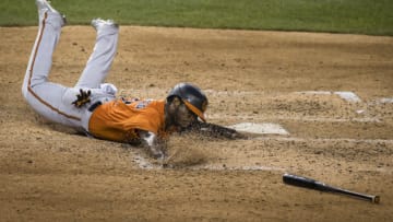 WASHINGTON, DC - JULY 21: Dilson Herrera #19 of the Baltimore Orioles slides into home plate to score a run against the Washington Nationals during the seventh inning at Nationals Park on July 21, 2020 in Washington, DC. (Photo by Scott Taetsch/Getty Images)