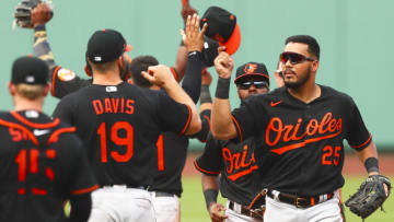 BOSTON, MA - JULY 26: The Baltimore Orioles tap hats after defeating the Boston Red Sox at Fenway Park on July 26, 2020 in Boston, Massachusetts. (Photo by Adam Glanzman/Getty Images)