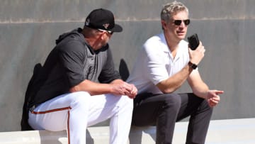 Baltimore Orioles manager Brandon Hyde (18) and Baltimore Orioles general manager Mike Elias talk during the spring training workout at Ed Smith Stadium. Mandatory Credit: Jonathan Dyer-USA TODAY Sports