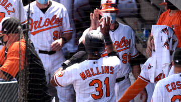 Mar 2, 2021; Sarasota, Florida, USA; Baltimore Orioles outfielder Cedric Mullins (31) is greeted by teammates in the dugout after scoring a run in the first inning against the New York Yankees during spring training at Ed Smith Stadium. Mandatory Credit: Jonathan Dyer-USA TODAY Sports