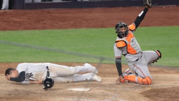Apr 7, 2021; Bronx, New York, USA; Baltimore Orioles catcher Pedro Severino (28) tags out New York Yankees third baseman Gio Urshela (29) at home plate to the end the game on a double play in the eleventh inning at Yankee Stadium. Mandatory Credit: Vincent Carchietta-USA TODAY Sports