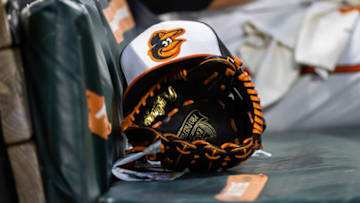Jun 1, 2021; Baltimore, Maryland, USA; A Baltimore Orioles hat and glove are seen in the dugout during the fourth inning of the game between the Baltimore Orioles and the Minnesota Twins at Oriole Park at Camden Yards. Mandatory Credit: Scott Taetsch-USA TODAY Sports