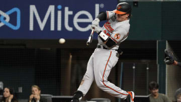 Aug 2, 2022; Arlington, Texas, USA; Baltimore Orioles catcher Adley Rutschman (35) hits a double during the fifth inning against the Texas Rangers at Globe Life Field. Mandatory Credit: Raymond Carlin III-USA TODAY Sports