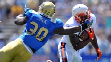 September 5, 2015; Pasadena, CA, USA; Virginia Cavaliers running back Albert Reid (5) runs the ball against the defense of UCLA Bruins linebacker Myles Jack (30) during the first half at the Rose Bowl. Mandatory Credit: Gary A. Vasquez-USA TODAY Sports