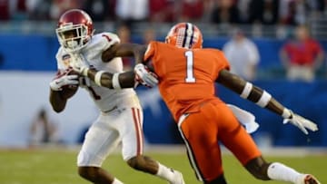 Dec 31, 2015; Miami Gardens, FL, USA; Oklahoma Sooners wide receiver Jarvis Baxter (1) eludes the tackle of Clemson Tigers safety Jayron Kearse (1) during the second quarter of the 2015 CFP semifinal at the Orange Bowl at Sun Life Stadium. Mandatory Credit: Tommy Gilligan-USA TODAY Sports