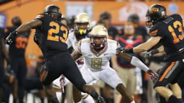 Aug 30, 2014; Arlington, TX, USA; Florida State Seminoles safety Jalen Ramsey (8) prepares to tackle against Oklahoma State Cowboys running back Rennie Childs (23) at AT&T Stadium. Mandatory Credit: Matthew Emmons-USA TODAY Sports