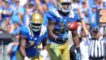 September 5, 2015; Pasadena, CA, USA; UCLA Bruins linebacker Myles Jack (30) celebrates after running in the ball for a touchdown on offense against the Virginia Cavaliers during the second half at the Rose Bowl. Mandatory Credit: Gary A. Vasquez-USA TODAY Sports