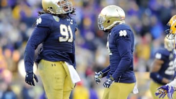 Dec 30, 2014; Nashville, TN, USA; Notre Dame Fighting Irish defensive lineman Sheldon Day (91) celebrates after recovering a fumble during the second half against the LSU Tigers in the Music City Bowl at LP Field. Notre Dame won 31-28. Mandatory Credit: Christopher Hanewinckel-USA TODAY Sports