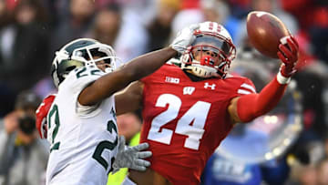 MADISON, WISCONSIN - OCTOBER 12: Adam Krumholz #24 of the Wisconsin Badgers is defended by Josiah Scott #22 of the Michigan State Spartans during the second half of a game at Camp Randall Stadium on October 12, 2019 in Madison, Wisconsin. (Photo by Stacy Revere/Getty Images)